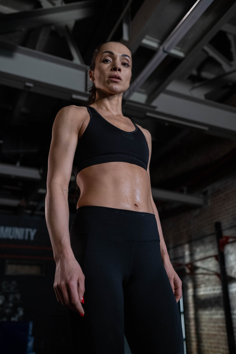 Low-Angle Shot of a Woman in Black Sports Bra and Black Leggings